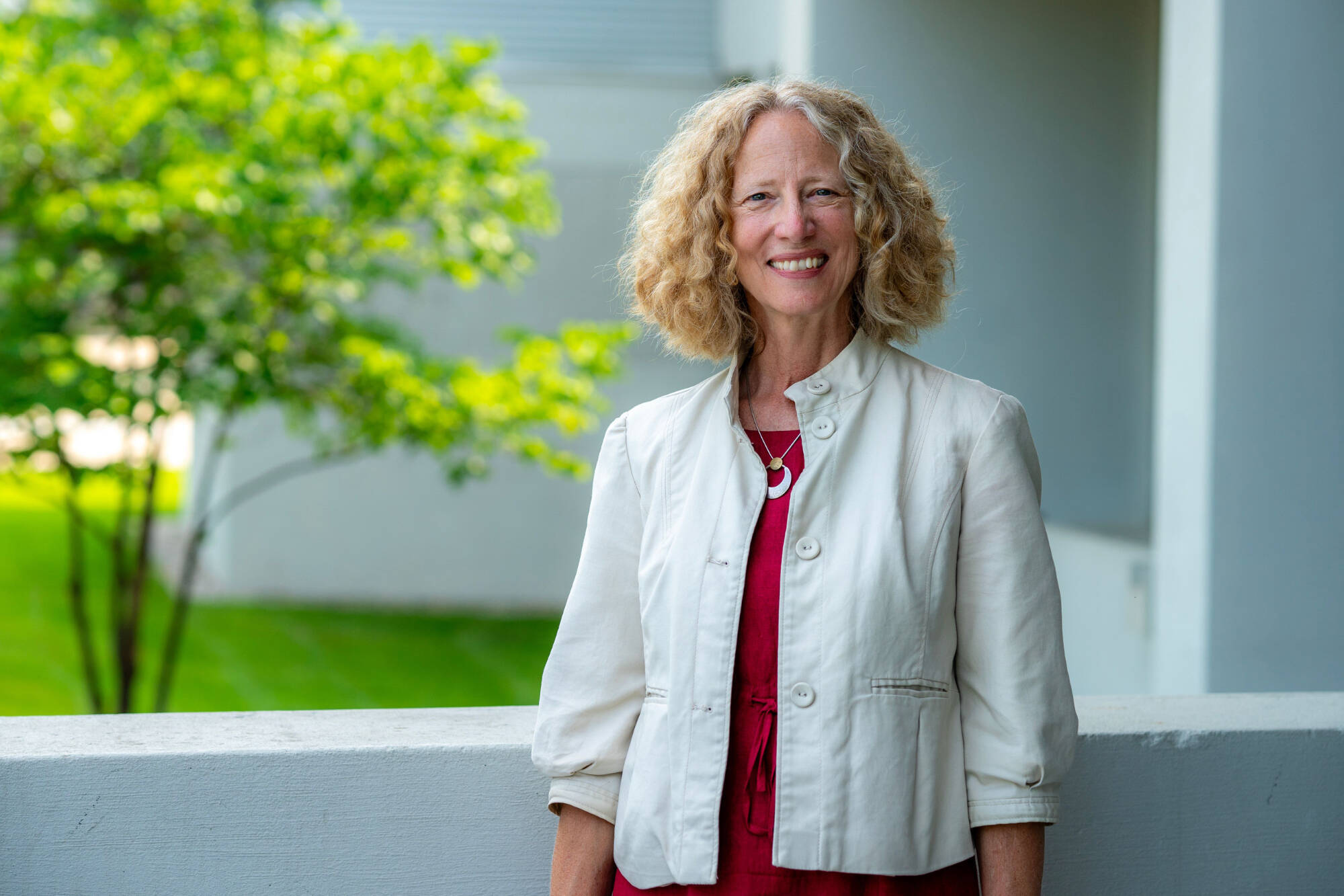 Jennifer Drake wearing a white jacket and red shirt